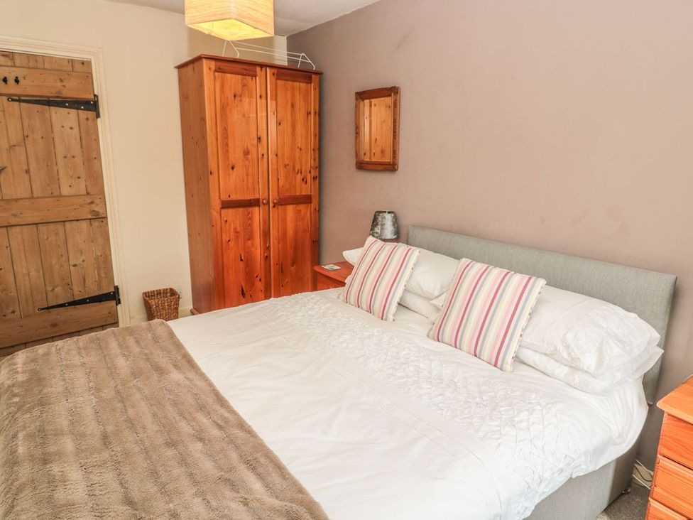 A bedroom with a bed and wardrobe at Shepherds Nook in Chathill