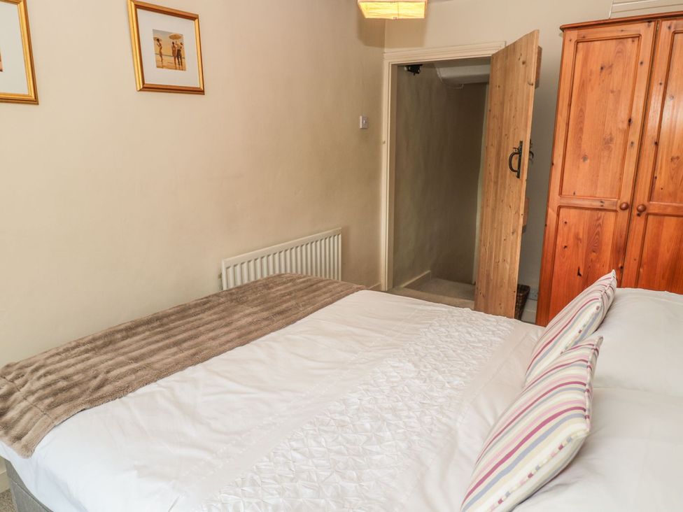 A bedroom with a bed and wardrobe at Shepherds Nook in Chathill