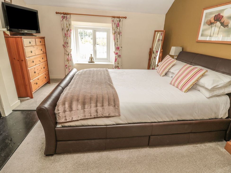 A bedroom with a bed and dresser at Shepherds Nook in Chathill