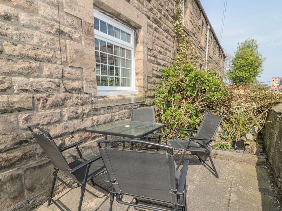 An outdoor seating area with a table and chairs at Shepherds Nook in Chathill