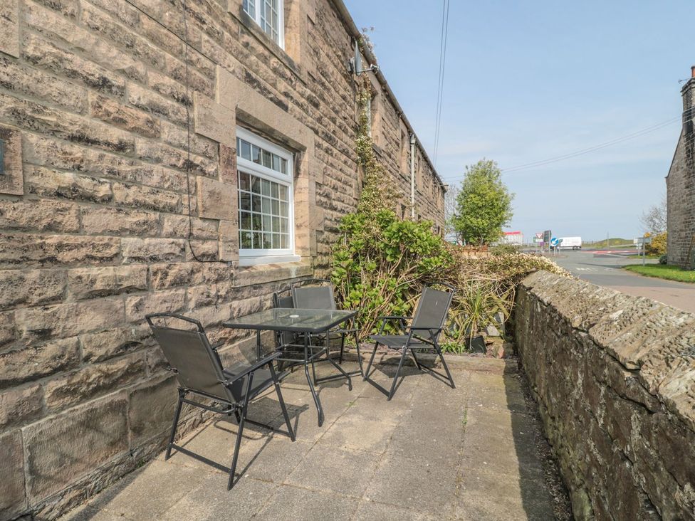 An outdoor seating area with a table and chairs at Shepherds Nook in Chathill