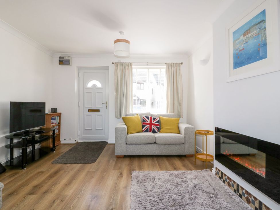 A living room with a sofa and television at Seahorses in Padstow