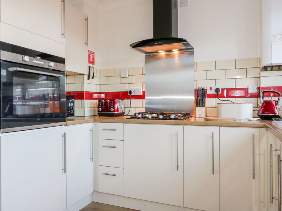 A kitchen with an oven, gas stove and kettle at Seahorses Padstow