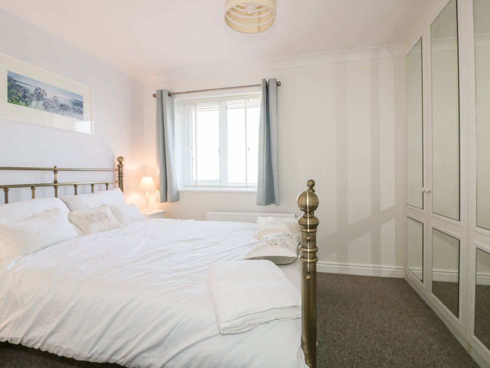 A bedroom with a bed and a wardrobe at Seahorses in Padstow