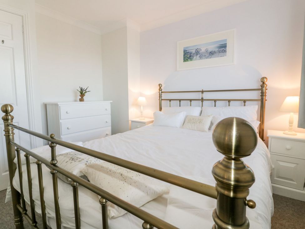 A bedroom with a bed and a wardrobe at Seahorses in Padstow