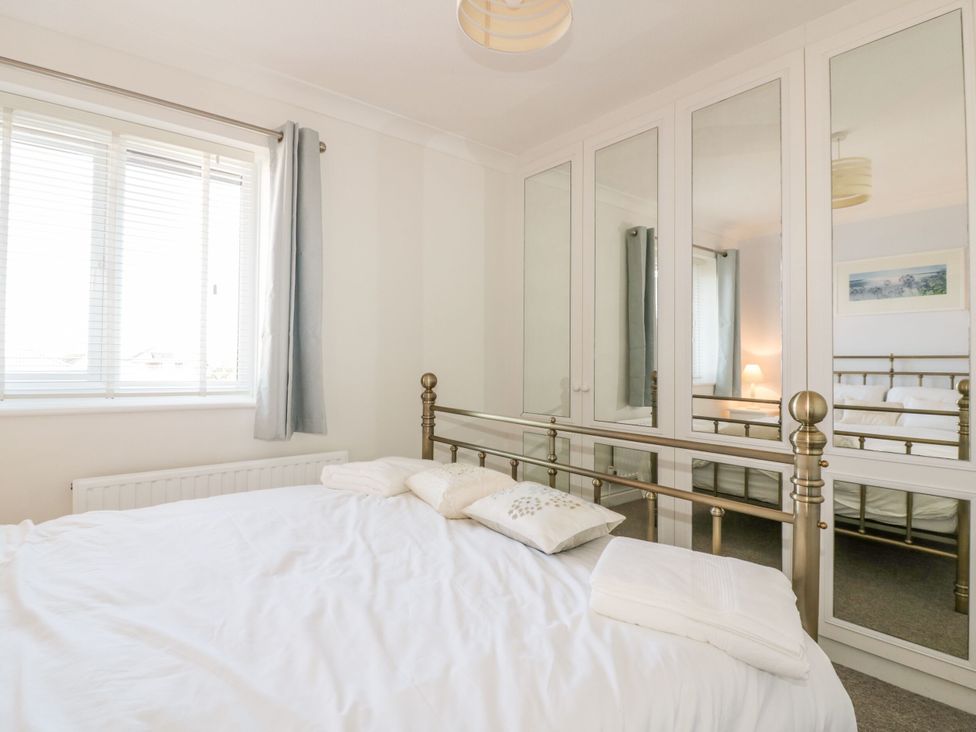 A bedroom with a bed and wardrobe at Seahorses Padstow