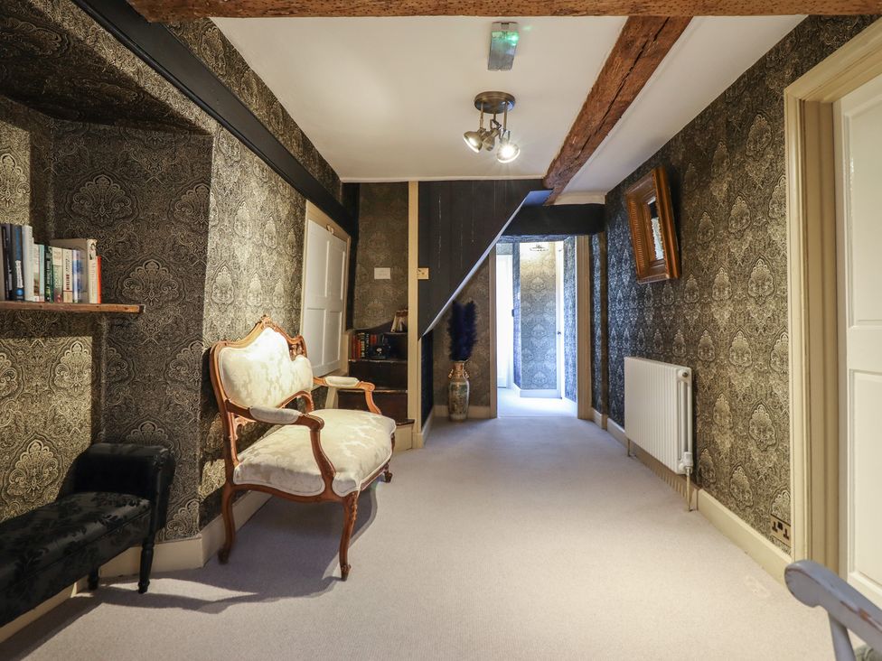 A hallway with furniture and decor at Plas Dolguog in Machynlleth