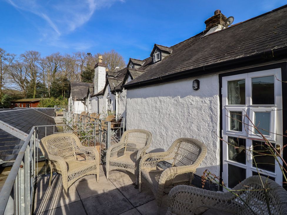 A deck area with chairs at Plas Dolguog in Machynlleth