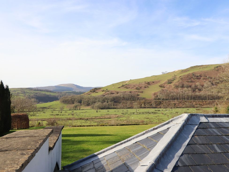 A landscape view featuring hills and grass at Plas Dolguog in Machynlleth