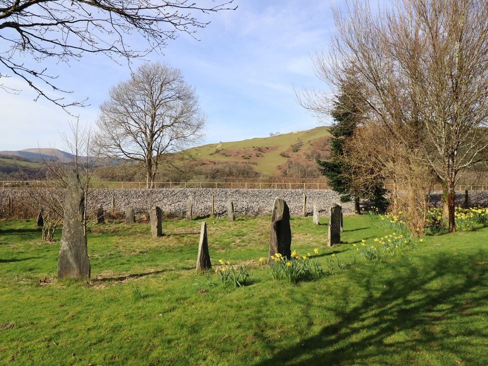 A landscape with stone formations and trees at Plas Dolguog Machynlleth