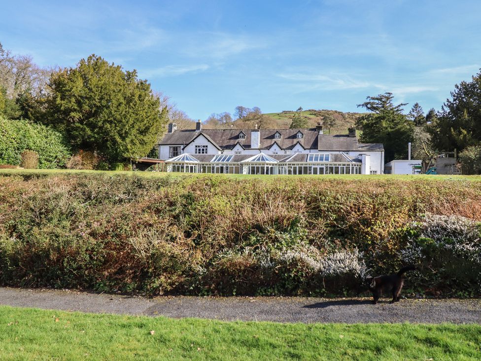 A house with a garden and pathway at Plas Dolguog in Machynlleth