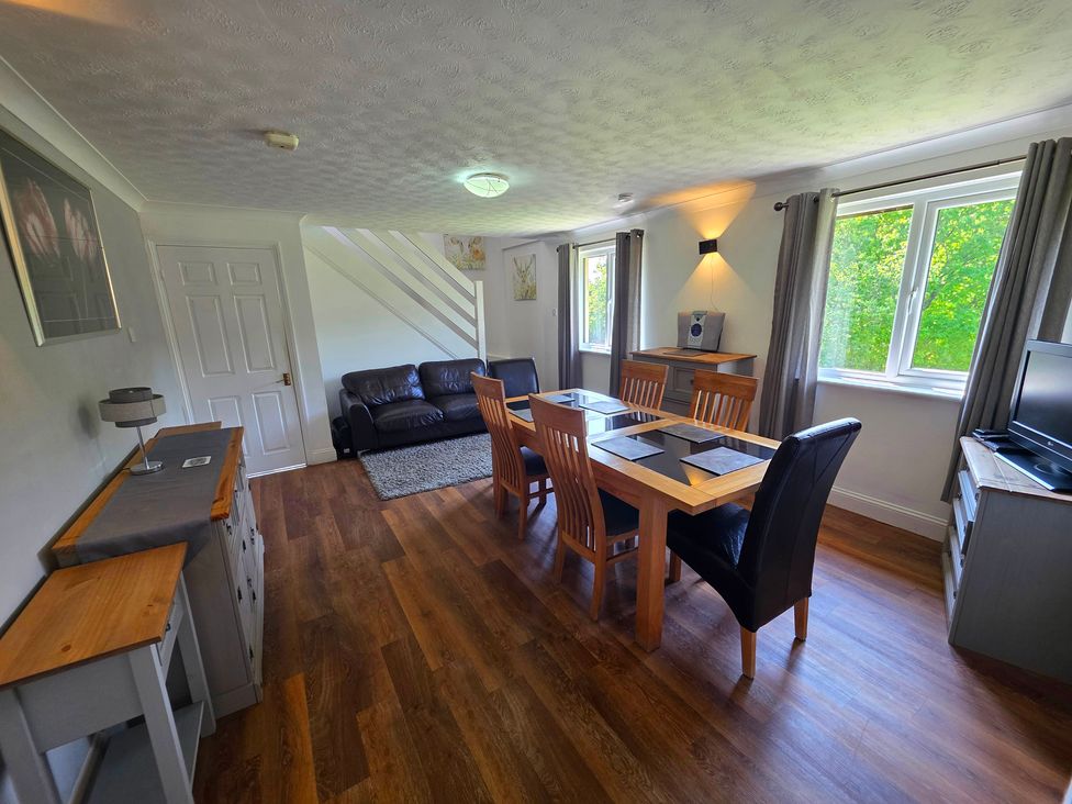 A living room with a dining table and chairs at Lakeview Villa near Liskeard