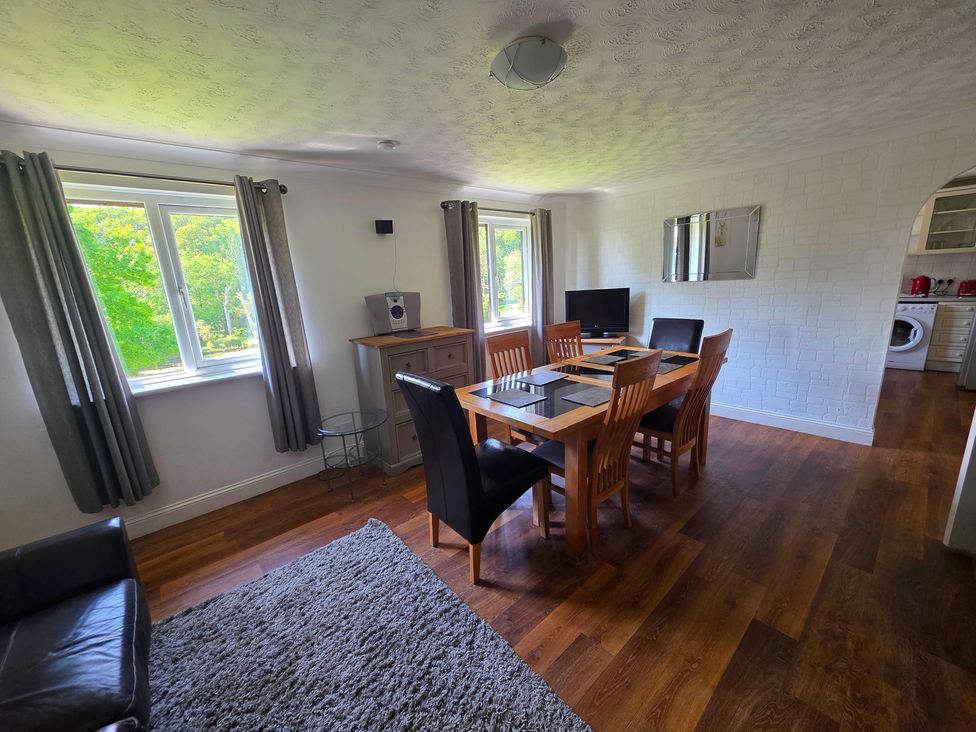 A dining room with a table and chairs at Lakeview Villa near Liskeard