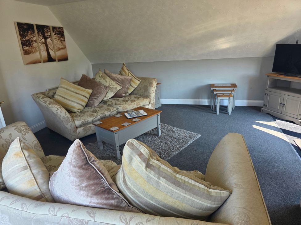 A living room with sofas and a television at Lakeview Villa near Liskeard