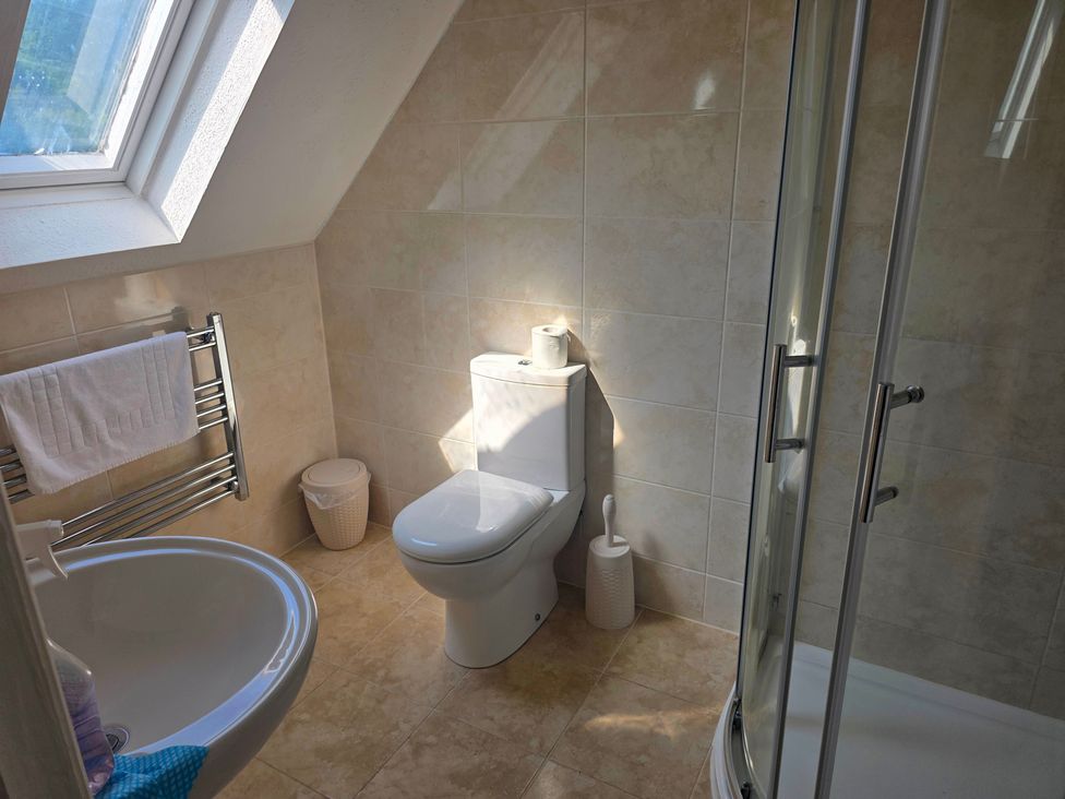 A bathroom with a shower and bathtub at Lakeview Villa near Liskeard