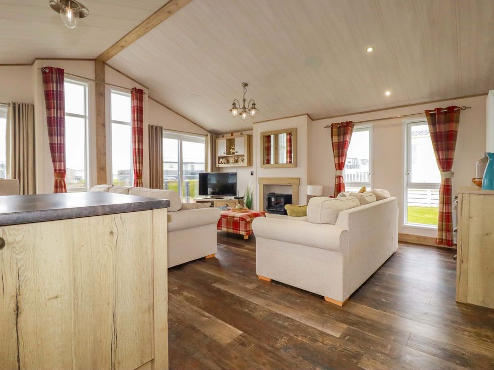 A living room with a sofa and television at 8 Summerleaze in Bude