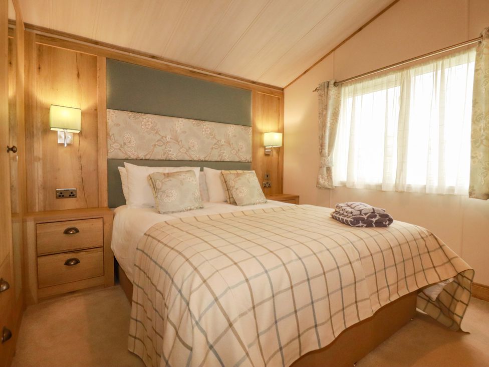 A bedroom with a bed and curtains at 8 Summerleaze Bude