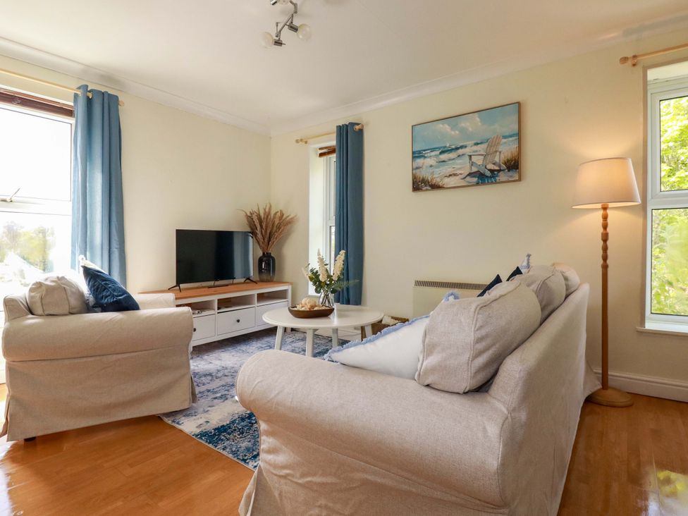 A living room with a television and sofa at Flat 5 in Looe