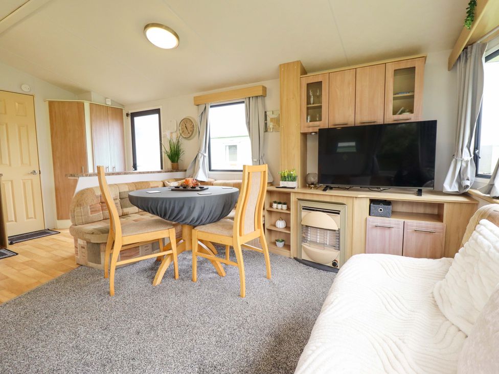 A living room with a dining table and sofa at Southview Leisure Park - Firs 83 Skegness