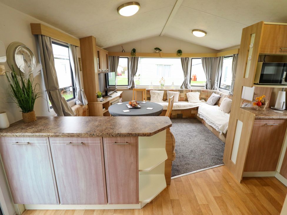 A living room with a sofa and table at Southview Leisure Park - Firs 83, Skegness