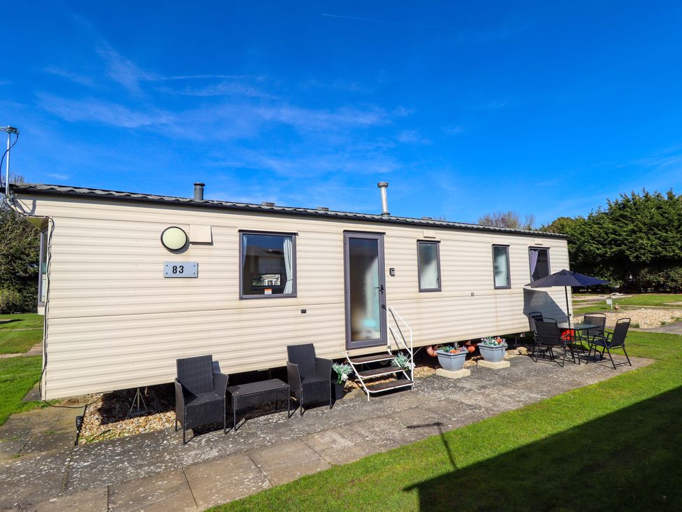 A mobile home with outdoor seating area at Southview Leisure Park - Firs 83 Skegness