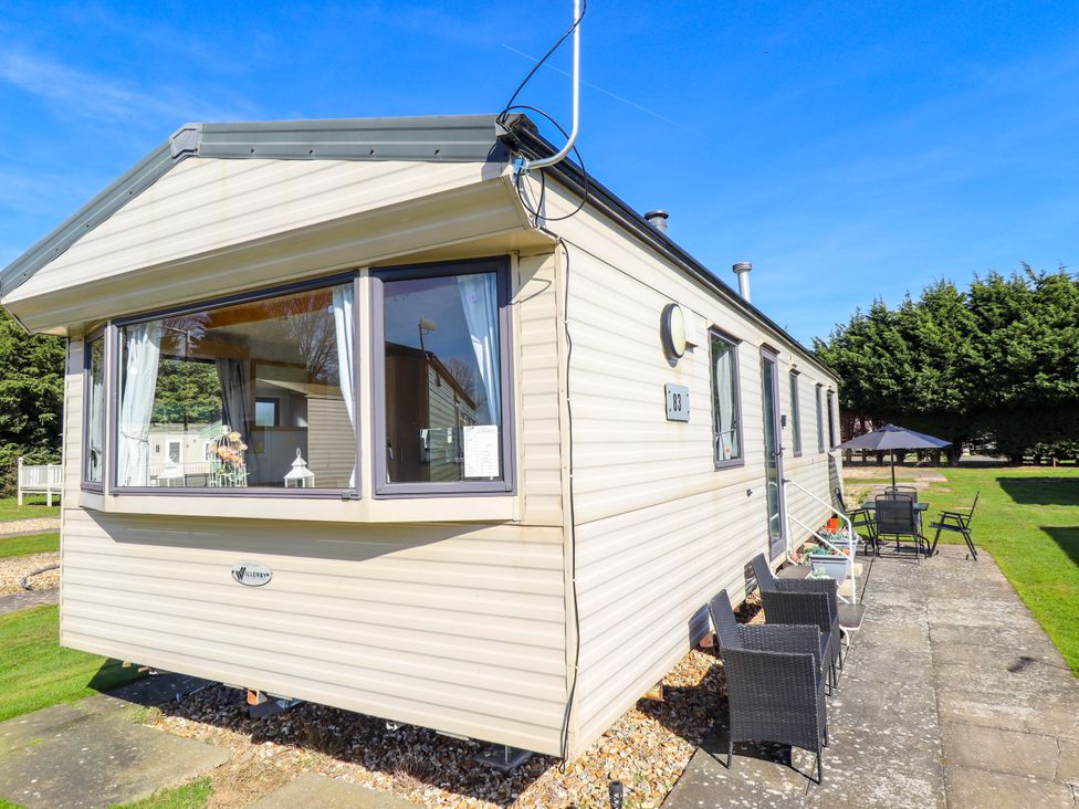 A caravan with chairs and a table outside at Southview Leisure Park - Firs 83 Skegness