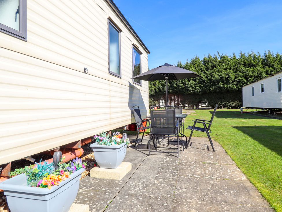 An outdoor area with a table and chairs at Southview Leisure Park - Firs 83, Skegness