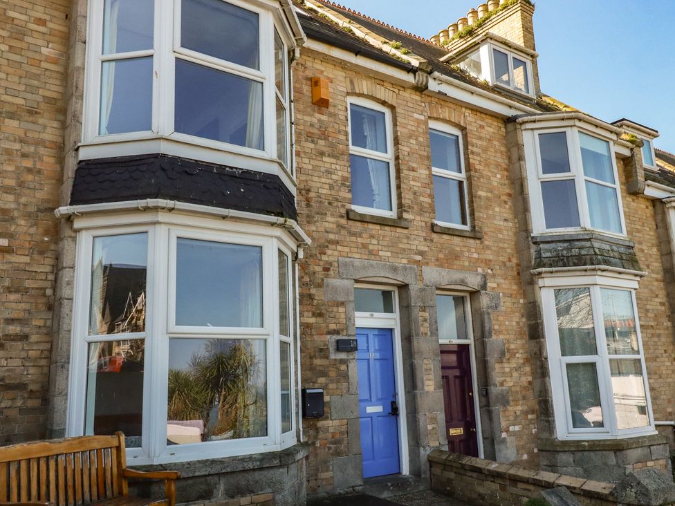 An outdoor view of a building with multiple windows and doors at Sea View in Newquay