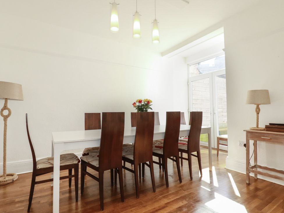 A dining room with a table and chairs at Sea View in Newquay