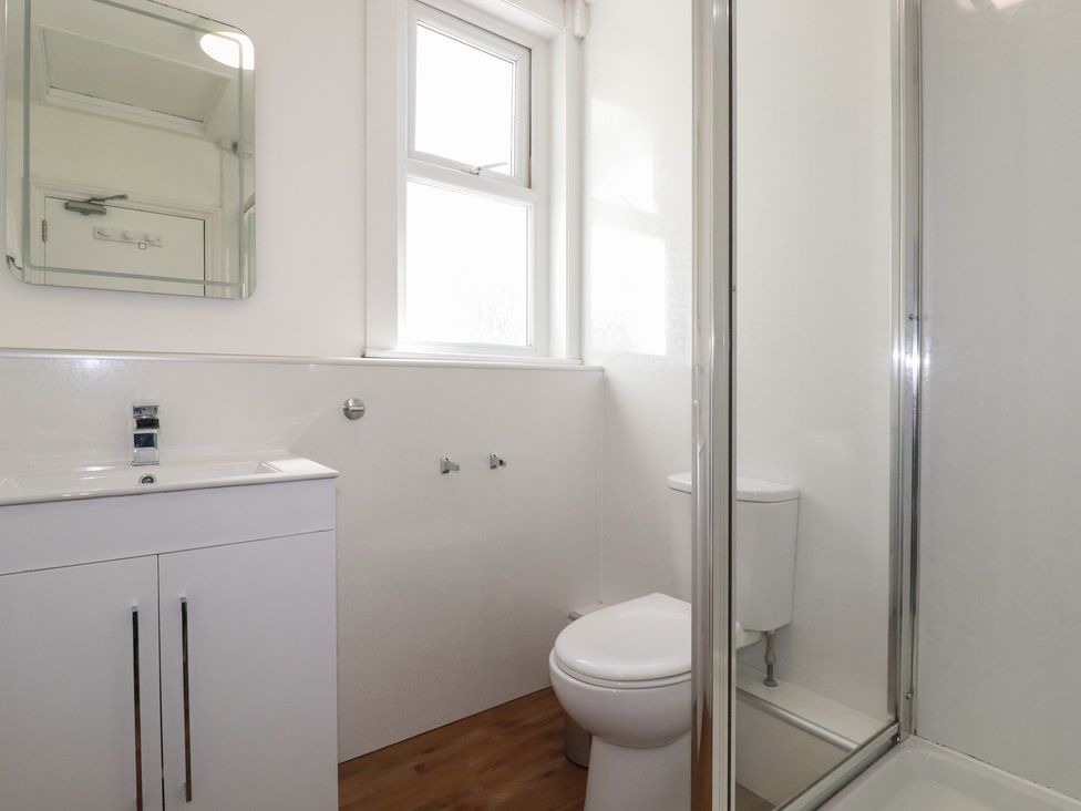 A bathroom with a sink, toilet, and shower at Sea View in Newquay