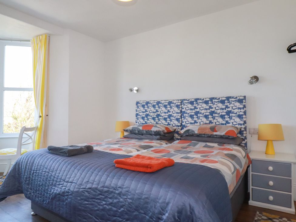 A bedroom with a bed and a bedside lamp at Sea View in Newquay