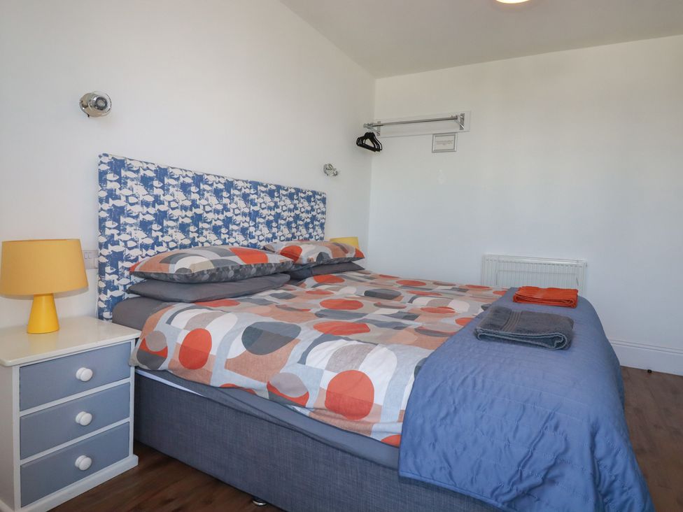 A bedroom with a bed and bedside table at Sea View in Newquay