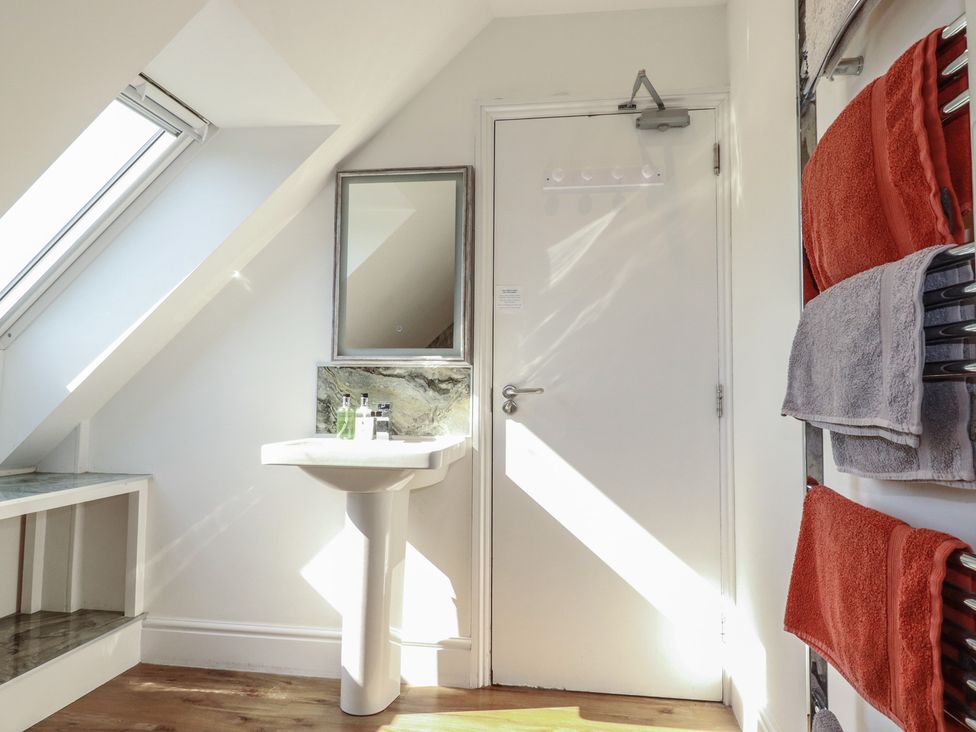 A bathroom with a sink and a mirror at Sea View in Newquay