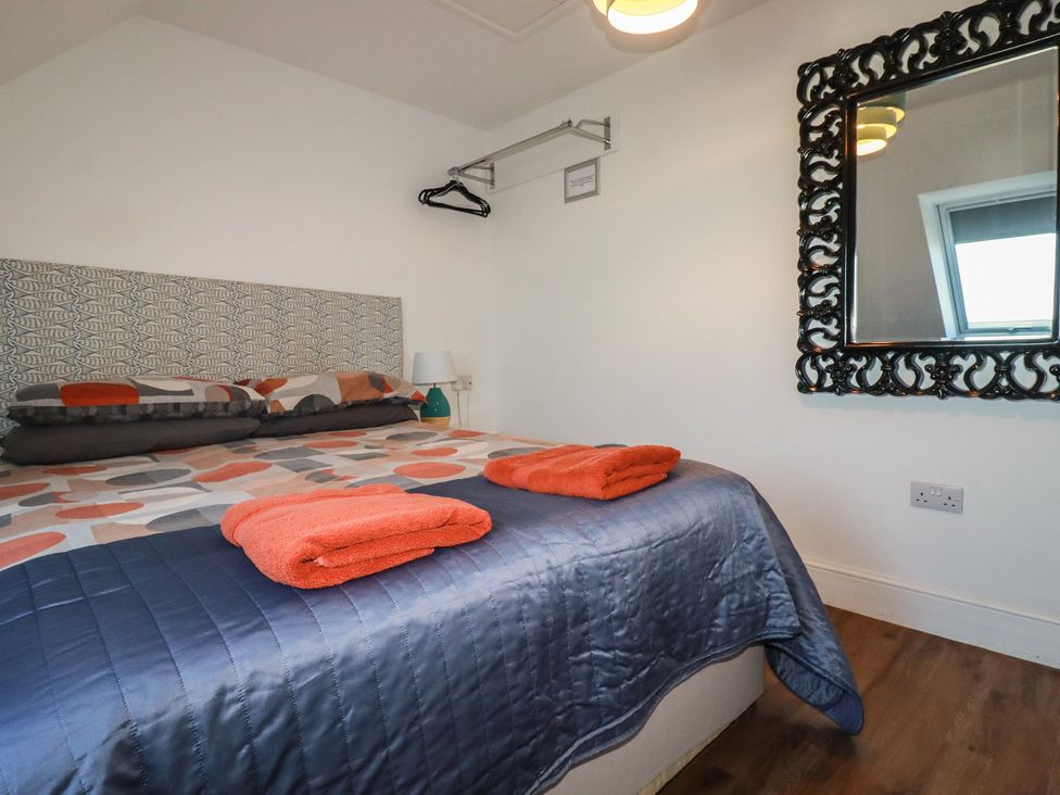 A bedroom with a bed and towels on it at Sea View in Newquay