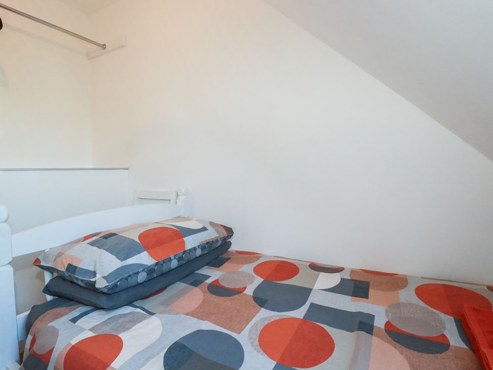 A bedroom with a bed and pillows at Sea View in Newquay