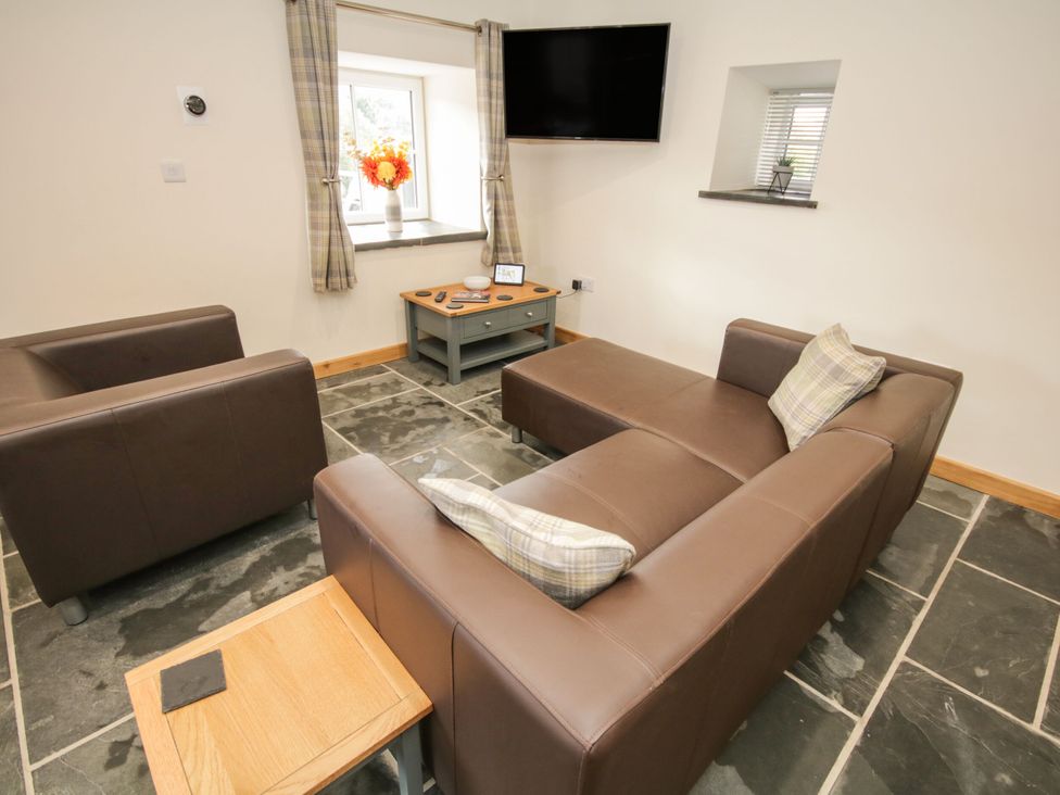 A living room with a sofa and coffee table at Sun Trevor Barn 1 in Llangollen