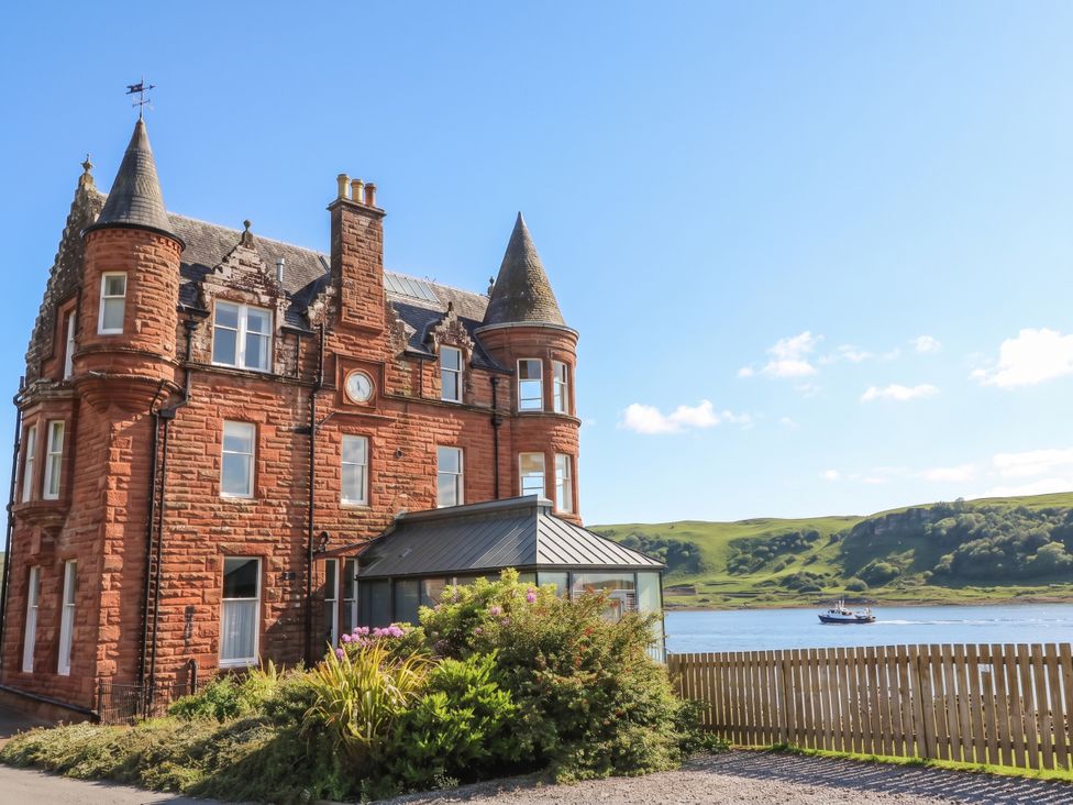 A building with a conservatory and views by a water at Heather Island View