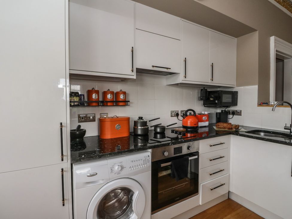 A kitchen with various appliances and storage at Heather Island View