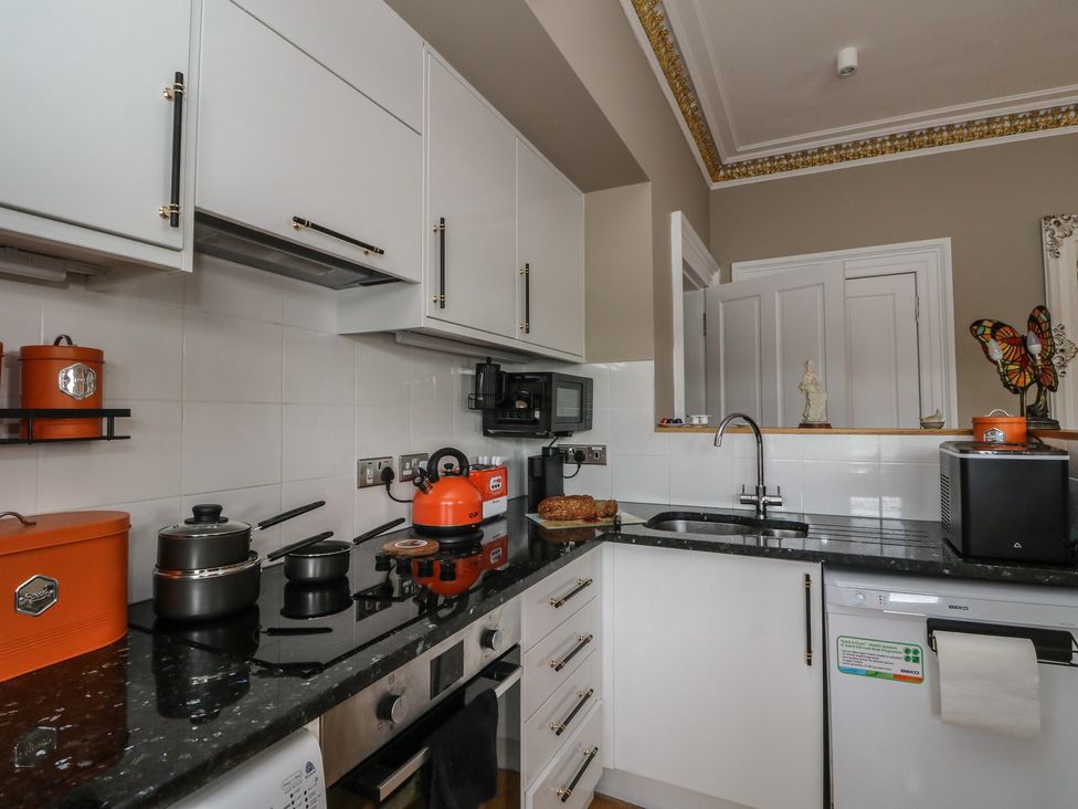 A kitchen featuring a sink, stove, and various appliances at Heather Island View