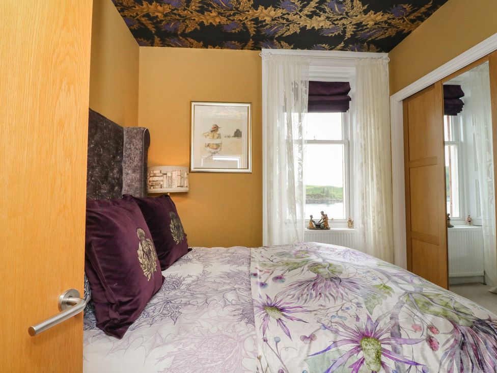A bedroom with a bed and window at Heather Island View