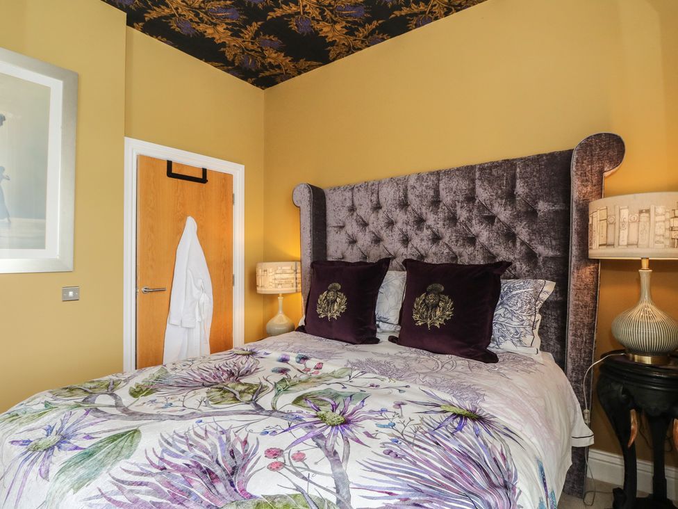 A bedroom with a bed and bedside table at Heather Island View