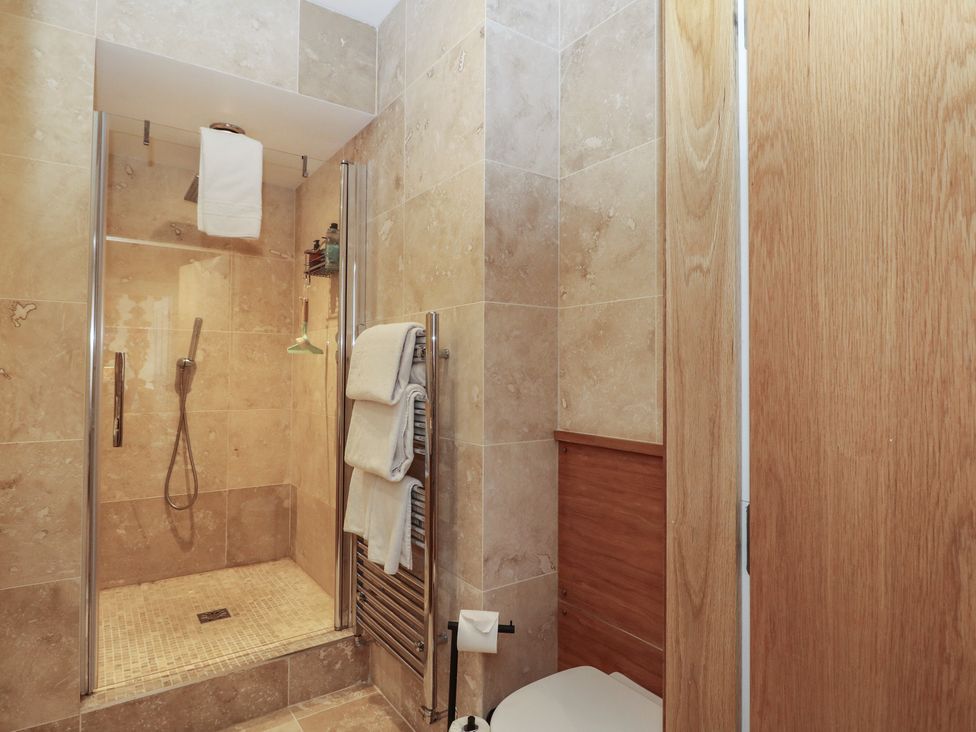 A bathroom with a shower and towels at Heather Island View