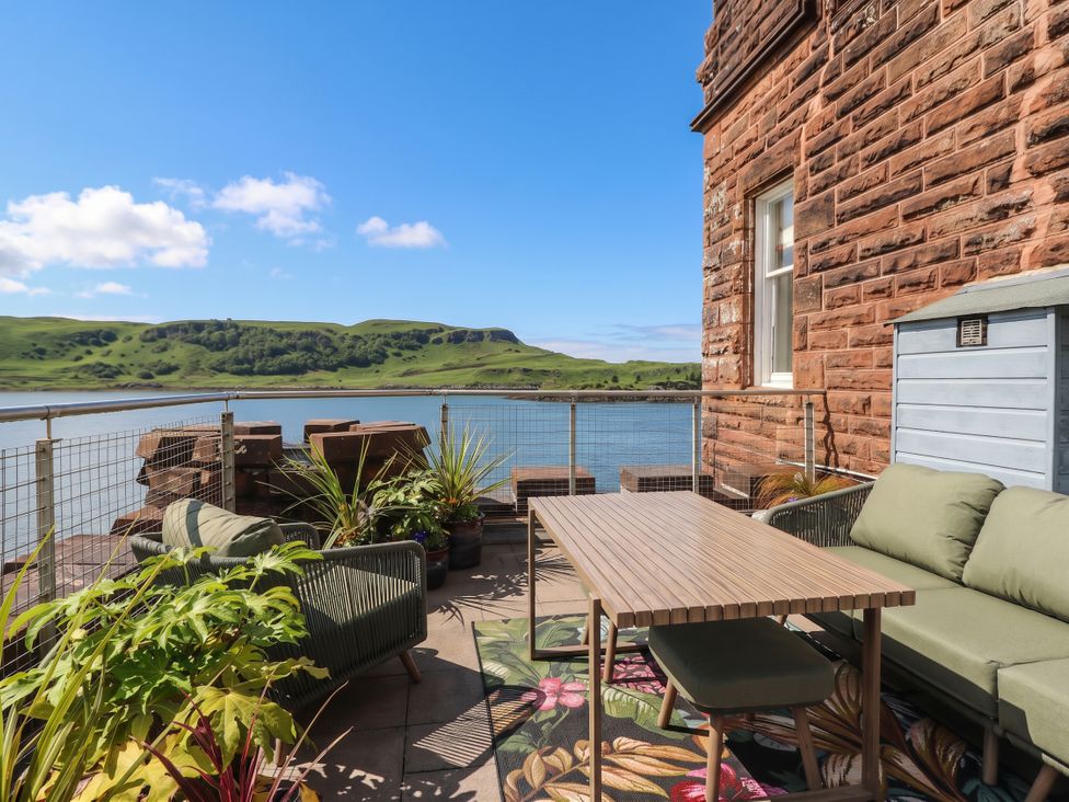 An outdoor seating area with a table and chairs at Heather Island View