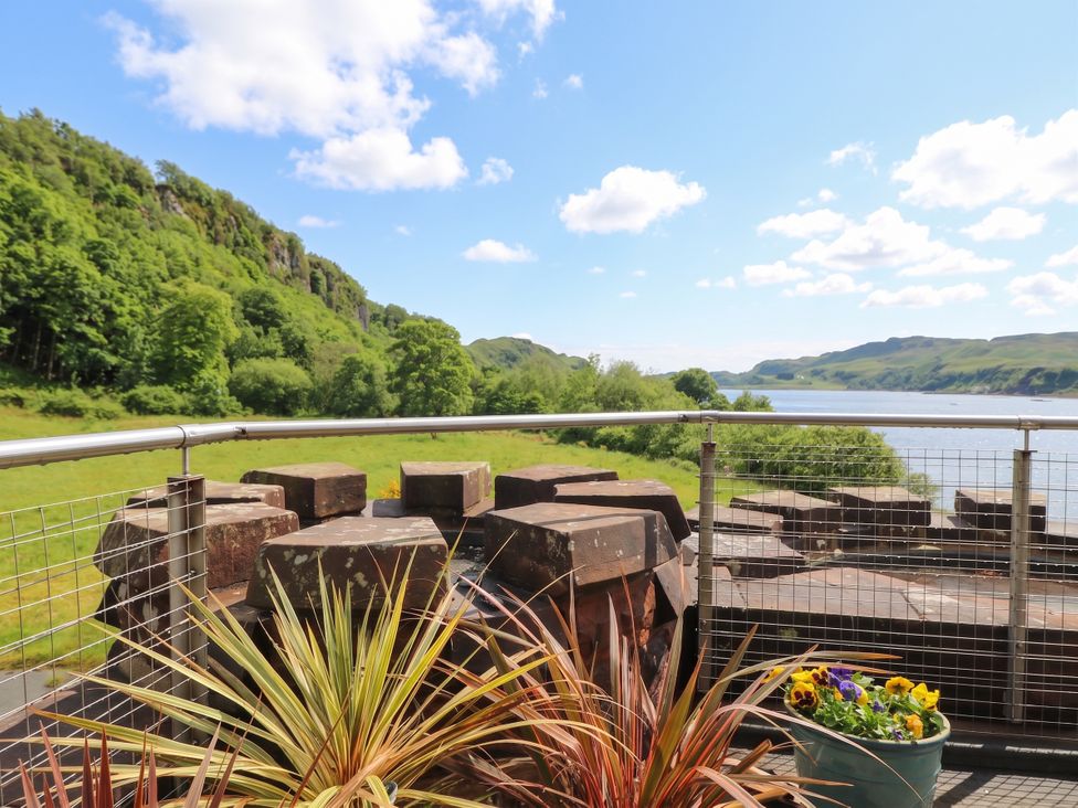 An outdoor area with plants and rocks overlooking a water view at Heather Island View