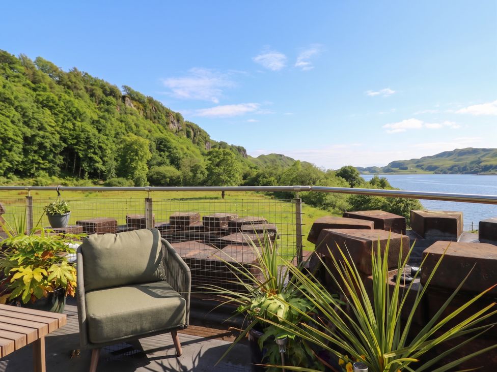 A balcony with plants overlooking a river at Heather Island View