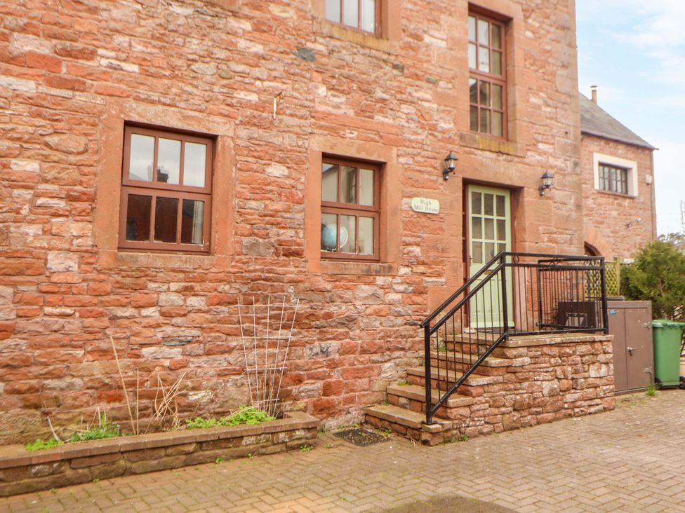 An exterior view of a building with stone walls and windows at High Mill House Penrith