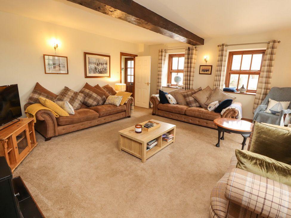 A living room with two sofas and a coffee table at High Mill House Penrith