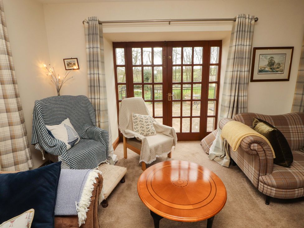 A living room with chairs and a coffee table at High Mill House in Penrith