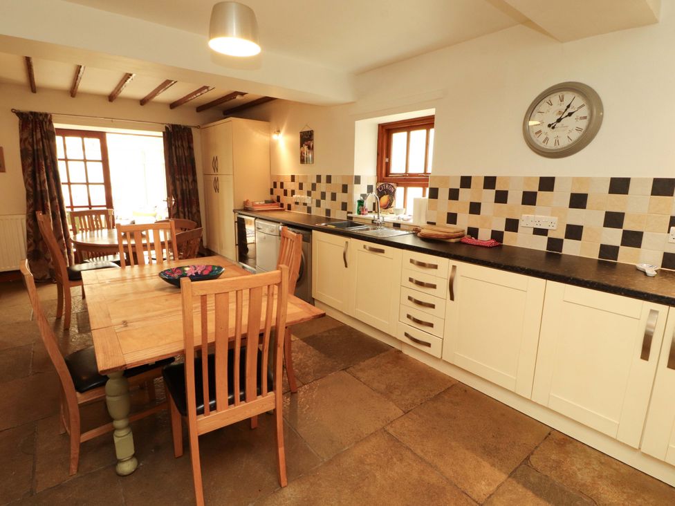 A kitchen with table and chairs at High Mill House in Penrith