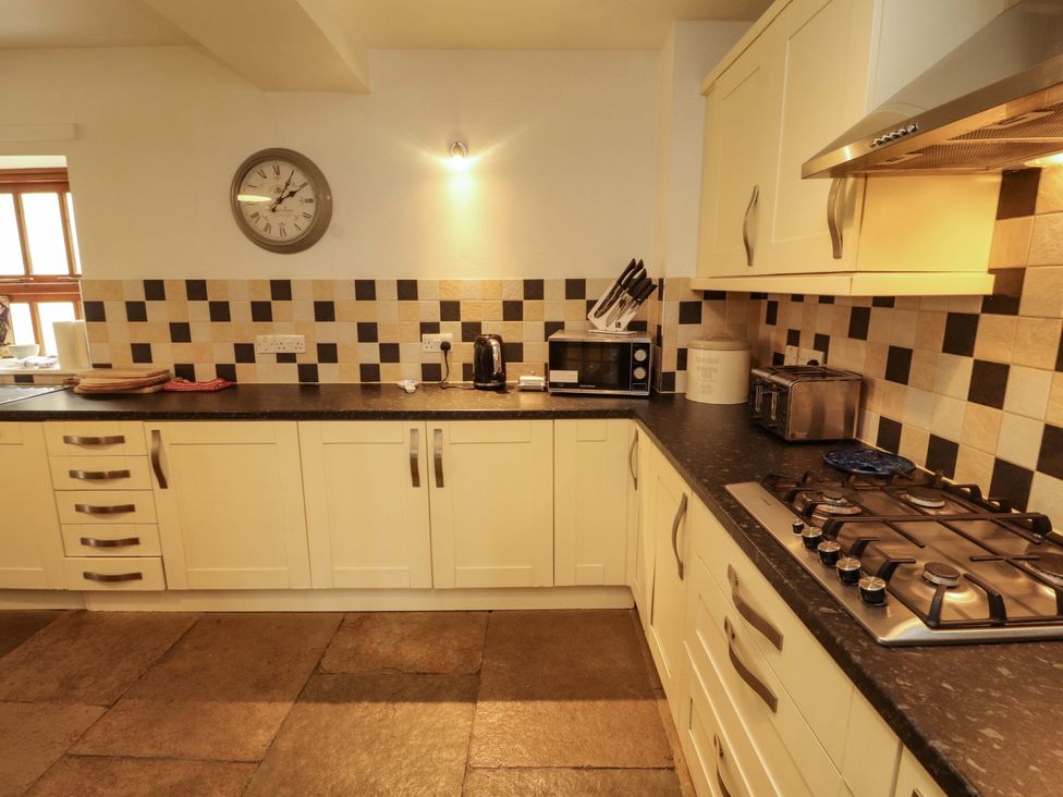 A kitchen with cabinets and appliances at High Mill House in Penrith